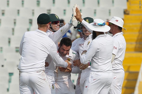 Dean Elgar of South Africa celebrates the wicket of Wriddhiman Saha in the Mohali Test.